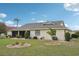 Well-maintained backyard with green lawn, shrubs, and a screened-in lanai for outdoor living at 1972 Wolf Laurel Dr, Sun City Center, FL 33573