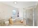 Bright bathroom offers a corner tub with tile surround, glass shower and a vanity with ample counter space at 1972 Wolf Laurel Dr, Sun City Center, FL 33573