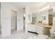 Bright bathroom featuring a vanity, walk in shower and walk-in closet at 1972 Wolf Laurel Dr, Sun City Center, FL 33573