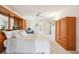 Bright bedroom featuring plush carpet, built-in wood storage, and ensuite bathroom at 1972 Wolf Laurel Dr, Sun City Center, FL 33573