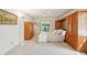 Cozy bedroom showcases built in wood storage, plush carpeting and access to a screened outdoor area at 1972 Wolf Laurel Dr, Sun City Center, FL 33573
