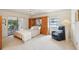 Comfortable bedroom featuring built-in storage, ceiling fan and sliding glass doors to an outdoor patio at 1972 Wolf Laurel Dr, Sun City Center, FL 33573