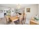 Bright dining room features chandelier, neutral walls, and hardwood table that seats six at 1972 Wolf Laurel Dr, Sun City Center, FL 33573