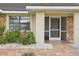 Inviting entryway featuring a screened front door and brick flooring complemented by decorative stone accents at 1972 Wolf Laurel Dr, Sun City Center, FL 33573
