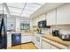 Traditional kitchen with white cabinetry, tile floors, and stainless steel appliances at 1972 Wolf Laurel Dr, Sun City Center, FL 33573