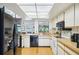 Bright kitchen featuring wood floors, stainless steel appliances, and natural light at 1972 Wolf Laurel Dr, Sun City Center, FL 33573