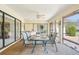 Well-appointed lanai with a dining area, wet bar, and seamless access to the outdoors at 1972 Wolf Laurel Dr, Sun City Center, FL 33573