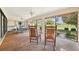 Relaxing lanai with rocking chairs and scenic views of the surrounding landscape at 1972 Wolf Laurel Dr, Sun City Center, FL 33573