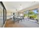Bright and airy lanai featuring a dining set and views of the lush backyard at 1972 Wolf Laurel Dr, Sun City Center, FL 33573