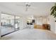 Living space featuring dining area, kitchen, view to the patio and neutral decor at 1972 Wolf Laurel Dr, Sun City Center, FL 33573