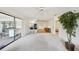 Open-concept living area showcasing the kitchen, dining area, and access to outdoor space at 1972 Wolf Laurel Dr, Sun City Center, FL 33573