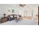 Cozy living room featuring a ceiling fan and views of the front entry at 1972 Wolf Laurel Dr, Sun City Center, FL 33573