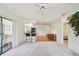 Bright, open living space featuring a view of the kitchen, dining area, and bedroom entrance at 1972 Wolf Laurel Dr, Sun City Center, FL 33573