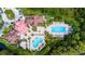 A top-down aerial view of a community pool and clubhouse, surrounded by lush greenery, offering a luxurious recreational space at 19836 Hidden Glen Dr, Land O Lakes, FL 34638