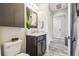 Charming bathroom featuring a granite countertop, decorative mirror, and wood-look tile at 19836 Hidden Glen Dr, Land O Lakes, FL 34638