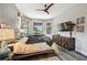 Spacious bedroom with unique lighting, stylish decor, and a view from the large bay windows at 19836 Hidden Glen Dr, Land O Lakes, FL 34638
