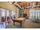 A clubhouse space with a pool table, high ceilings, and access to a dining room, perfect for entertaining guests at 19836 Hidden Glen Dr, Land O Lakes, FL 34638