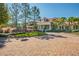 Beautiful clubhouse featuring a red metal roof, white columns and a brick circular driveway at 19836 Hidden Glen Dr, Land O Lakes, FL 34638