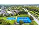Aerial shot of tennis and basketball courts in a community, with trees and nearby houses in the background at 19836 Hidden Glen Dr, Land O Lakes, FL 34638