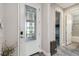 Elegant foyer with a decorative glass front door, stylish flooring, and open view of the home's interior at 19836 Hidden Glen Dr, Land O Lakes, FL 34638