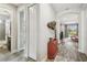Hallway leading to a living room with a decorative chest and wood-look tile at 19836 Hidden Glen Dr, Land O Lakes, FL 34638