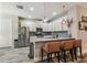 Modern kitchen with white cabinets, stainless appliances, breakfast bar, and stylish pendants at 19836 Hidden Glen Dr, Land O Lakes, FL 34638