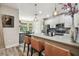 Bright kitchen featuring quartz counters, stainless appliances, and breakfast bar seating three at 19836 Hidden Glen Dr, Land O Lakes, FL 34638