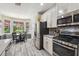 Charming kitchen featuring modern stainless steel appliances, wood flooring, and a breakfast nook with a view at 19836 Hidden Glen Dr, Land O Lakes, FL 34638
