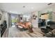 Open-concept living room with stylish seating, wood-look floors, and access to the pool area at 19836 Hidden Glen Dr, Land O Lakes, FL 34638