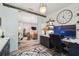 Open office space with glass barn door, desk, and sleek gray and white cabinetry at 19836 Hidden Glen Dr, Land O Lakes, FL 34638