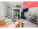 Cozy patio with ceiling fan, outdoor seating, TV, and a beautiful view of the pool at 19836 Hidden Glen Dr, Land O Lakes, FL 34638