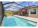 A sparkling swimming pool with a screened enclosure and patio furniture for relaxing poolside at 19836 Hidden Glen Dr, Land O Lakes, FL 34638