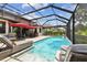 Stunning pool area with lounge chairs, outdoor lighting, and a screened enclosure at 19836 Hidden Glen Dr, Land O Lakes, FL 34638