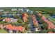 Picturesque aerial view of lakeside condos featuring red tile roofs, scenic walking paths, and serene water features for relaxed living at 2400 Feather Sound Dr # 1235, Clearwater, FL 33762