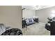 Versatile bedroom setup with a futon, desk, and exercise equipment for a functional living space at 2400 Feather Sound Dr # 1235, Clearwater, FL 33762