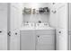 Laundry room featuring a washer, dryer, and storage shelf at 2400 Feather Sound Dr # 1235, Clearwater, FL 33762