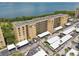 Aerial view of condos with lake view and covered parking in the foreground at 2617 Cove Cay Dr # 206, Clearwater, FL 33760