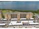 Aerial view of condos with lake in the background and parking in the foreground at 2617 Cove Cay Dr # 206, Clearwater, FL 33760