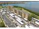 Aerial view of condos with parking area and lake view in the background at 2617 Cove Cay Dr # 206, Clearwater, FL 33760