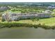 Aerial view showcases waterfront condos next to green space, ponds, and manicured landscapes at 2617 Cove Cay Dr # 206, Clearwater, FL 33760