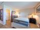 Cozy bedroom featuring wood-look floors and furniture, with a walk-in closet at 2617 Cove Cay Dr # 206, Clearwater, FL 33760
