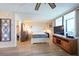 Bright bedroom featuring a large window and an entertainment center with mounted TV at 2617 Cove Cay Dr # 206, Clearwater, FL 33760