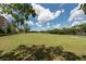 Wide lawn view of the condos with manicured landscaping and blue skies at 2617 Cove Cay Dr # 206, Clearwater, FL 33760