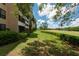 Beautiful landscaping, lawn and exterior view of the condo, next to a golf course at 2617 Cove Cay Dr # 206, Clearwater, FL 33760