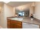 Kitchen sink featuring warm wood cabinets and pass through to adjacent rooms at 2617 Cove Cay Dr # 206, Clearwater, FL 33760