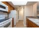 Compact kitchen featuring wooden cabinets and essential appliances at 2617 Cove Cay Dr # 206, Clearwater, FL 33760
