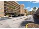Covered parking area with allocated parking spaces, in front of a multi-story complex at 2617 Cove Cay Dr # 206, Clearwater, FL 33760