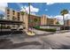 Designated parking area with covered spots, surrounded by lush landscaping and buildings at 2617 Cove Cay Dr # 206, Clearwater, FL 33760