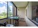 Enclosed patio with a glass table, seating, and a view of the outdoors at 2617 Cove Cay Dr # 206, Clearwater, FL 33760