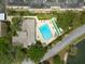Aerial view of a sparkling community pool with lounge chairs and lush landscaping near waterfront at 2617 Cove Cay Dr # 206, Clearwater, FL 33760